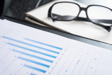 Business accessories on a background of diagrams. Copy space for text