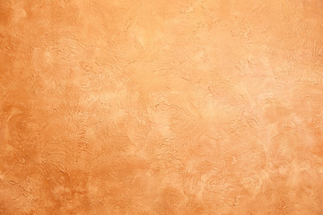 Beautiful textured wall of yellow color. Rough and rubbed