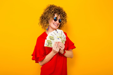 Attractive woman with short curly hair with cash