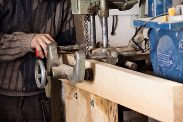 hand of a carpenter taking measurement of a wooden
