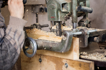 Carpenter using electric saw
