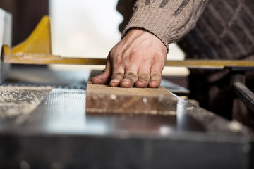 Carpenter using electric saw
