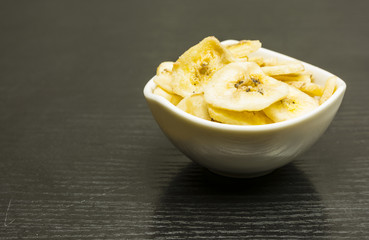 White bowl with dried banana.