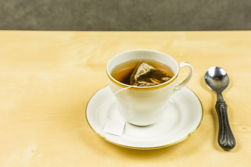 A cup of freshly brewed tea from a bag.