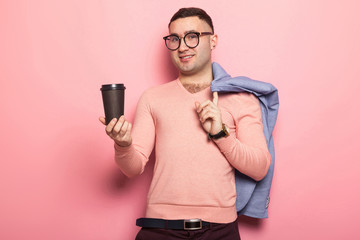 Handsome man in bright jacket with coffee cup