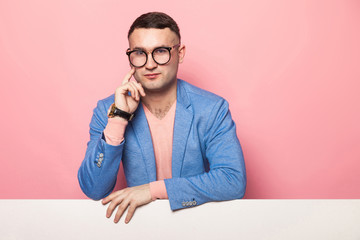 Handsome man in bright jacket with white banner