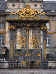 Golden gate of Palace of Justice in the Cite Island in Paris, France.