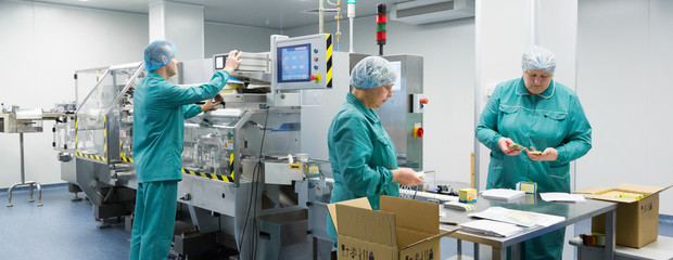 Pharmaceutical factory workers in sterile environment