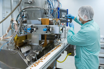Pharmacy industry factory man worker in protective clothing in sterile working conditions