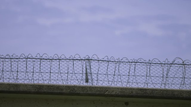 View of a modern prison and barbed wires on the walls