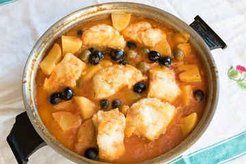 Salted cod stewed with olives