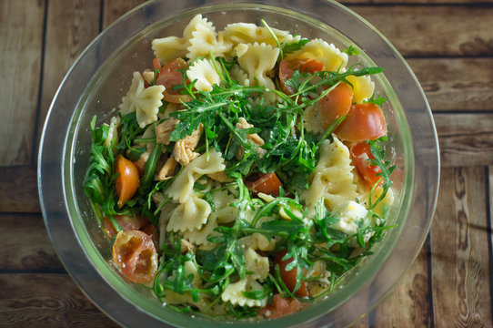 salad with rucola, chicken, feta cheese and pasta
