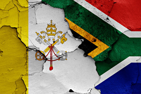flag of Vatican and South Africa painted on cracked wall