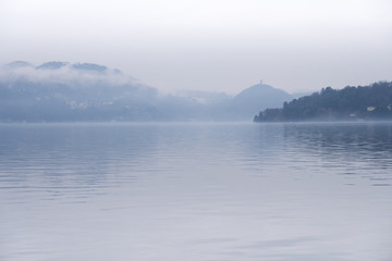 Quiet lake on a foggy day. Lake Orta in northern Italy in winter.