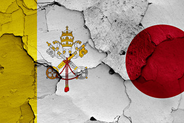 flag of Vatican and Japan painted on cracked wall