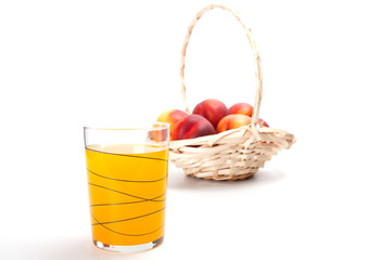 Peach fruit juice in glass isolated on white background