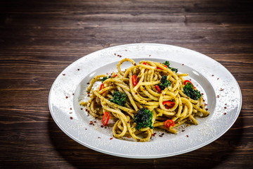 Pasta with collard on wooden table