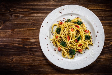 Pasta with collard on wooden table