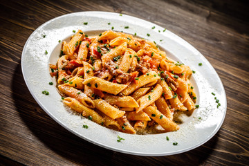 Penne with meat, tomato sauce and vegetables