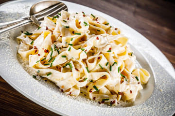 Pasta carbonara on wooden table