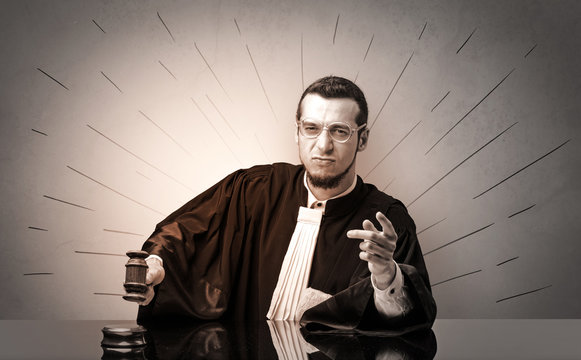 Oldscool young judge in gown deciding