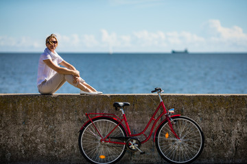 Fototapeta na wymiar Woman and bike on pier