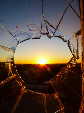 Sun rising over the countryside, viewed through a broken window - Uruguaiana, Brazil (pampa biome)