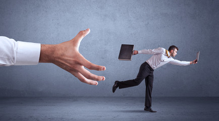Businessman running from hand