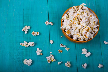 Popcorn explosion on blue background, Popcorn on blue top view copy space