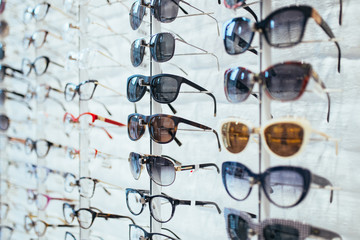 Sunglasses and eyeglasses frames in optical store. 
