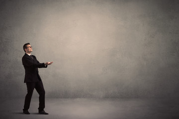 Businessman standing in front of a blank wall