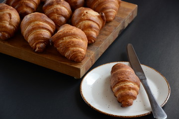 Fresh croissant on a black background.  