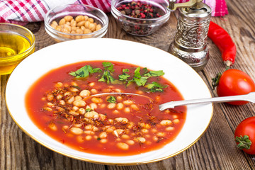 Hot spicy tomato soup with white beans and chili