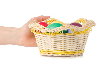 Easter color eggs in the basket in hand
