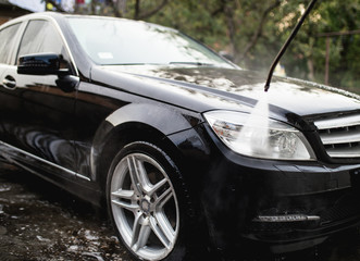 Obraz na płótnie Canvas Car wash with pressurized water, car detailing (or valeting) concept.