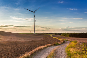 Sunset at countryside with wind turbine in autumn, Poland