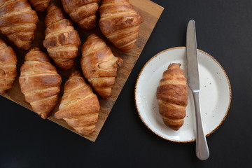 Fresh croissant on a black background.  