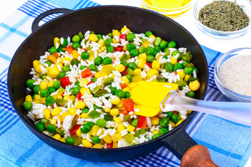 Frozen Hawaiian mix of vegetables with rice in frying pan