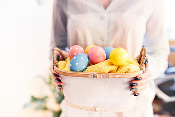 Fototapeta na wymiar girl holding a basket with Easter eggs