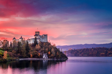 Beautiful castle by the lake at pink dusk, Poland