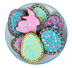 Easter homemade baked gingerbread cookies in the form of eggs with different pattern of icing on plate