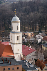 Fototapeta na wymiar High clock tower of the Saint Jadwiga Catholic church in Bolkow