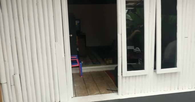 A group of young happy children running out of a doorway playing