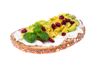 Whole grain bread with avocado, green sprouts and pomegranate seeds
