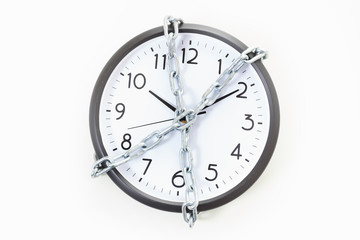 Chain holding an alarm wall clock, time management concept