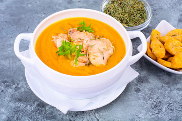 Pumpkin cream soup with slices of salmon