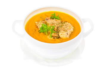 Pumpkin cream soup with slices of salmon