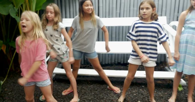 A diverse group of young girls learning how to dance together