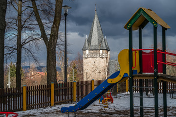 Fototapeta premium Children playground slide and Church tower