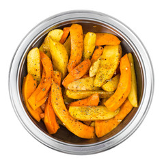 Raw potato slices and pumpkin with spices in metal bowl
